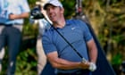 Rory McIlroy answers the call after a spot of mobile phone interference